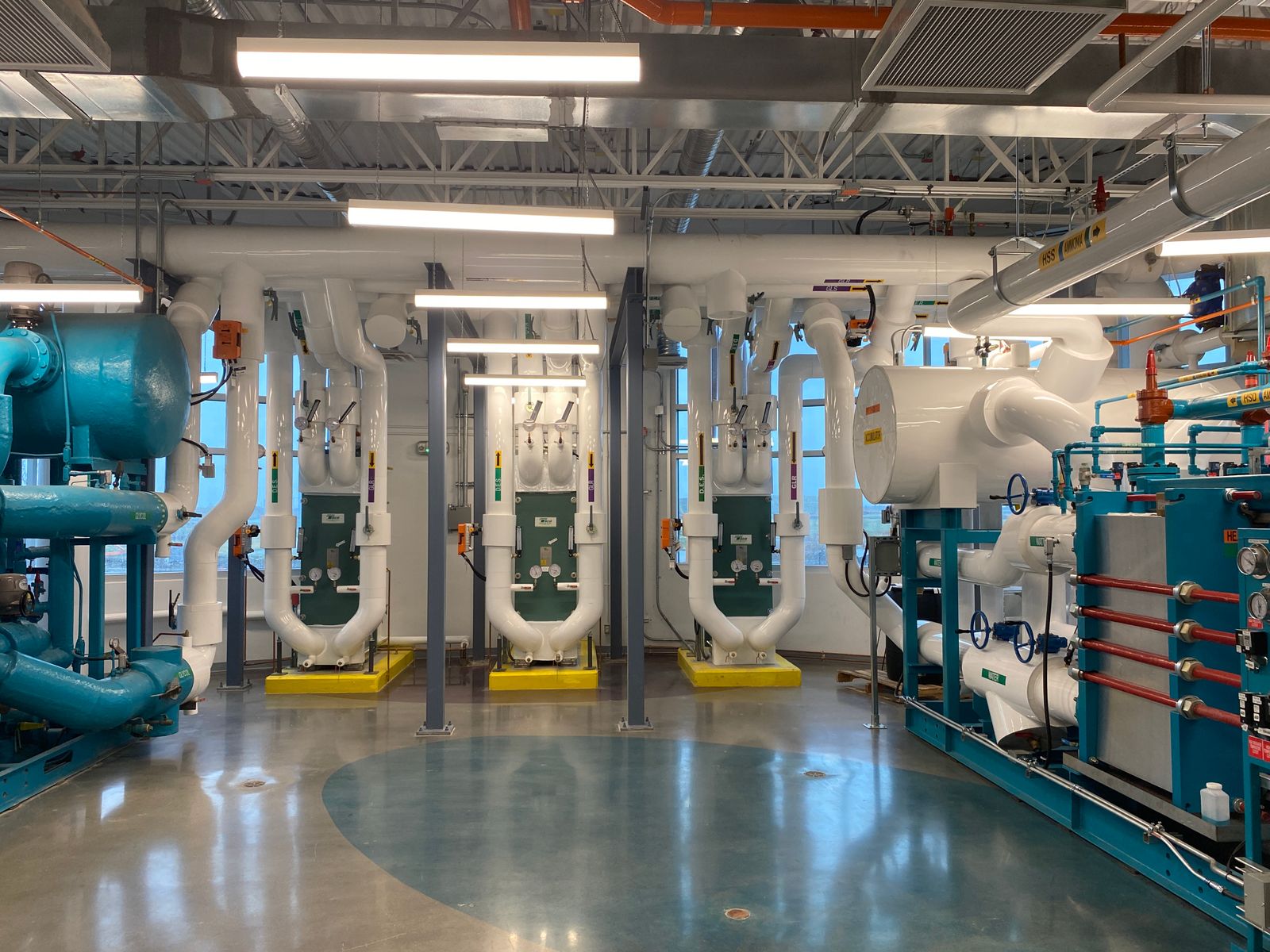 Building plant room with pumps, heat exchangers and manifolds